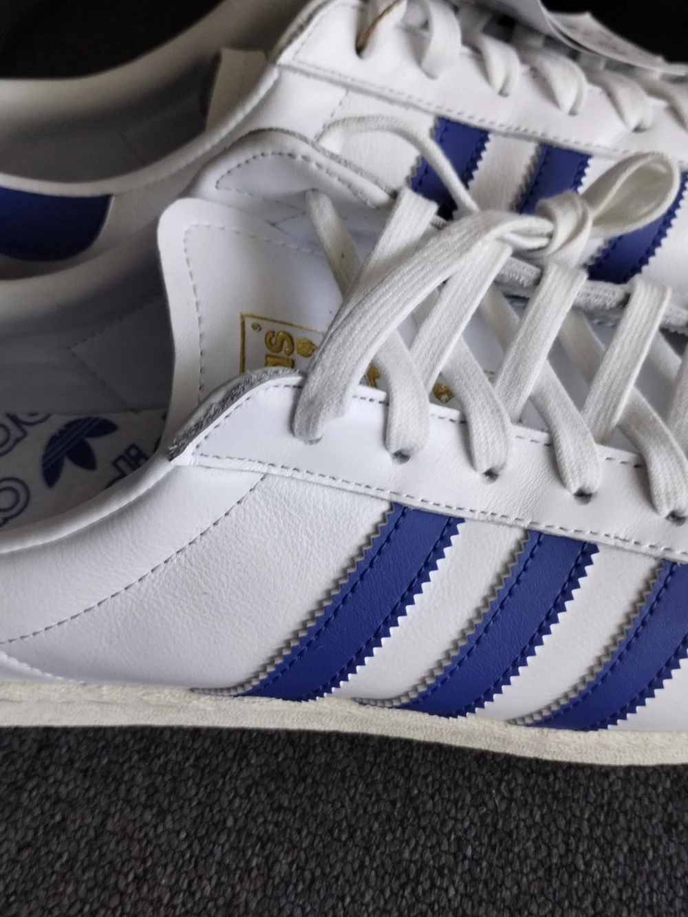 adidas White Sneakers with Blue Accents and Black Logo